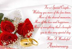 two red roses and wedding rings on a white sheet with congratulations message for a special couple