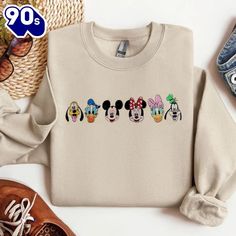 Mickey And Friends Embroidered Gildan Sweatshirt Introducing our Embroidered Sweatshirts – the perfect fusion of comfort and style. Crafted from premium, soft cotton-blend fabric, these sweatshirts are designed to keep you cozy while making a fashion statement. Each piece features intricate embroidery that adds a touch of elegance and individuality, elevating the classic sweatshirt into a standout wardrobe staple. Whether you’re lounging at home or heading out for a casual day, our embroidered sweatshirts offer a versatile and chic option. Available in a range of colors and designs, they make an ideal choice for those who appreciate quality craftsmanship and... Mickey Mouse Blanket, Simple Logos, Gildan Sweatshirt, Classic Sweatshirt, Gildan Sweatshirts, Intricate Embroidery, Embroidered Sweatshirt, Embroidered Sweatshirts, Mickey And Friends