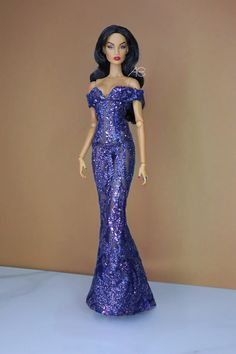 a barbie doll is wearing a purple dress