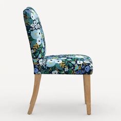 a blue floral upholstered chair with wooden legs