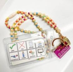 a beaded necklace with an identification card attached to it