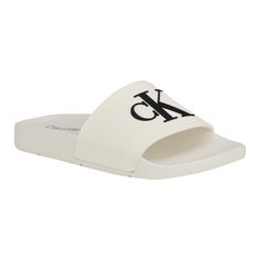 PRICES MAY VARY. A warm weather essential, the Calvin Klein Arin sandals are a must have for your wardrobe. This comfortable, slip-on look features a modern square toe and CK monogram detailing on the upper. Open Toe Slip on Closure Casual Calvin Klein Sandals With Cushioned Footbed, Calvin Klein Slides, Calvin Klein Slip-on Sandals For Summer, Calvin Klein Spring Slip-on Sandals, Calvin Klein Sandals, Ck Monogram, Womens Slides Sandals, Womens Slides, Calvin Klein Woman