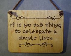 a wooden sign that says it is no bad thing to celebrate a simple life hanging on a wall