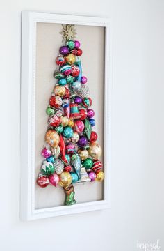 a christmas tree made out of ornaments in a white frame