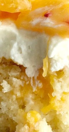 a close up of a piece of cake with white frosting and oranges on top