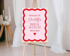 a welcome sign for the bride to be on an easel in front of a window