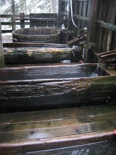 several wooden steps in the woods with water running down them