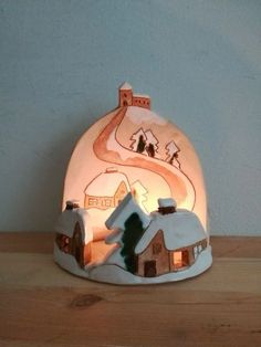 a lighted snow globe with houses on it