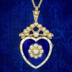 A beautiful antique Edwardian pendant from the turn of the 20th Century depicting a heart, with a pearl flower in the centre and a pearl bow on top. It's fashioned in 18ct gold and layered in a royal blue, guilloche enamel with a white border. It's very pretty and has remained in pristine condition. It's accompanied by a new 18ct wheat chain to display it on and is fitted with a pin at the back so it can also be worn as a brooch if preferred. We recommend you insure for £2,300. We can provide a Victorian Medallion Jewelry For Valentine's Day, Victorian Medallion Necklace For Valentine's Day, Victorian Heart-shaped Formal Necklace, Victorian Heart-shaped Necklace For Formal Occasions, Victorian Heart Pendant Necklace For Wedding, Victorian Heart Necklace For Formal Occasions, Victorian Heart Pendant Jewelry For Formal Occasions, Elegant Heart Pendant Necklace For Collectors, Heirloom Blue Necklaces For Weddings