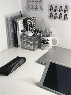 a laptop computer sitting on top of a white desk