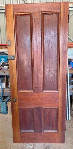 an old wooden door in a garage with no glass on the top and bottom panel