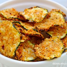 a white bowl filled with fried zucchini chips