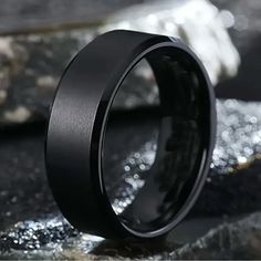 a black ring sitting on top of a rock