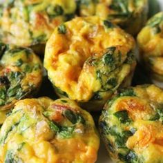 small muffins with cheese and spinach on a white plate, ready to be eaten