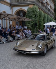 a car driving down the street with people watching