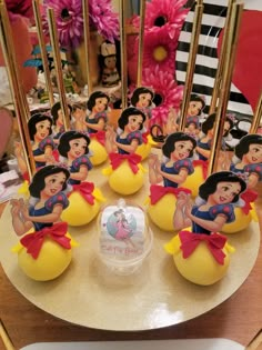 there is a cake that has snow white on it and other decorations in the background