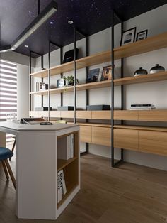 a kitchen with wooden shelves and blue chairs