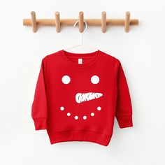 Looking for a cute sweatshirt for your kids? We have the perfect Snowman Face graphic sweatshirt addition to their closet! Playful Red Cotton Sweatshirt, Fun Red Tops For Fall, Red Cartoon Print Sweatshirt For Fall, Playful Red Sweatshirt For Fall, Playful Red Cotton Sweater, Playful Long Sleeve Red Sweater, Playful Fleece Crew Neck Sweatshirt, Playful Fleece Sweatshirt With Crew Neck, Playful Winter Crew Neck Sweatshirt