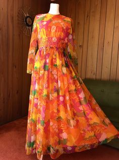 Beautiful party gown with the most psychedelic farm scene print - lovely flowers, trees, foliage and birds in vibrant shades of orange, yellow, pink and green - waistline beaded embellishments and zíper in the back. Size Medium Measurements in inches of garment laid flat: Shoulders 15' Bust 18' Waist 14' Hips up to 19' Length 56' Great Vintage condition! Please message if you have any questions. Multicolor Floral Print Dress For Fiesta, Multicolor Spring Maxi Dress For Fiesta, Multicolor Maxi Dress For Spring Fiesta, Spring Fiesta Multicolor Maxi Dress, Vintage Orange Dress For Festival, Beaded Embellishments, Gloria Steinem, Farm Scene, Party Gown