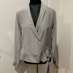 Elevate Your Wardrobe With This Stunning J Brand Blouse. Made From 100% Silk, Size Medium, And In A Gorgeous Light Gray Color. The Long Sleeves And V-Neckline Are Complemented By A Front Tie Closure, Adding A Touch Of Elegance To Any Outfit. Perfect For Work Or Any Occasion! Retailed For $248 + Tax! Chic Silver V-neck Top, Gray Formal Tops For Fall, Elegant Silver Blouse For Fall, Elegant Gray Workwear Tops, Elegant Gray Blouse For Workwear, Elegant Gray Tops For Workwear, Elegant Gray Tops For Work, Fall Season Silver V-neck Top, Elegant Silver Blouse For Formal Occasion