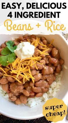 a bowl filled with beans and rice topped with sour cream, cheese and cilantro