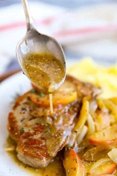 a spoon is lifting up some food from a plate