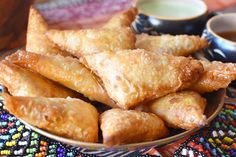 some fried food on a plate with dipping sauce