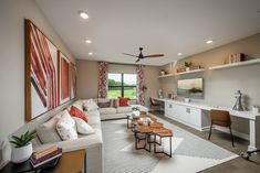 a living room filled with furniture and a flat screen tv on top of a wall