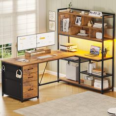 a desk with a computer on top of it in front of a window and a rug