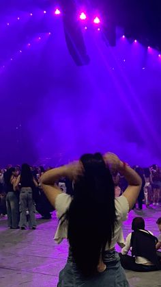 people sitting on the ground in front of purple lights