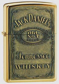 a gold colored zippo lighter with jack daniels on the front and one no 3 tennessee whiskey