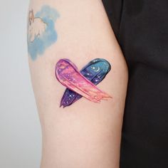 a woman with a tattoo on her arm that has an airplane flying in the sky