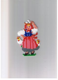 a cross - stitch pattern of a woman in a red dress with an apron and hat