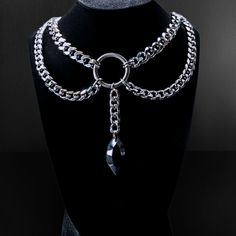 This elusive statement piece necklace features the ever coveted chunky cuban chain with curb chain draped accents that perfectly complement the elongated oval jewel. Each element of this design connect to a centralized O ring that flawlessly completes the look. Bewitching, classy, bold, and elegant; this design pairs well with a variety of styles. Specifications: ✌️Handmade item 🪙Materials: Stainless steel, Acrylic  🔗Chain Type: Cuban link choker with curb chain accents 📏Choker Size: 12 inche Metal Curb Chain Jewelry For Party, Party Curb Chain Choker Jewelry, Party Choker With Curb Chain, Edgy Chain Link Necklace For Parties, Edgy Chain Link Party Necklace, Black Metal Curb Chain Necklace, Metal Curb Chain Jewelry, Metal Jewelry With Chain Strap And Cuban Link, Punk Style Chain Link Jewelry With Chain Strap