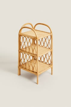 a small bamboo shelf with two baskets on it's sides and one holding a bottle