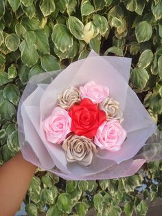 a person holding a bouquet of flowers in their hand