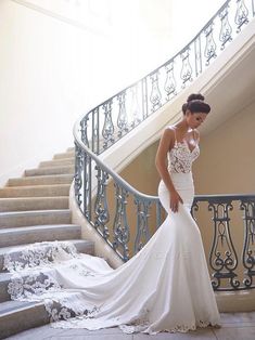 a woman in a wedding dress standing on stairs