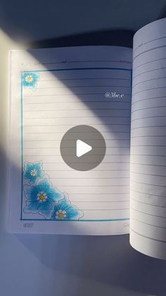 an open book with blue flowers on it