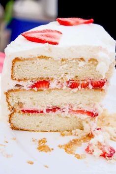 a slice of cake with white frosting and strawberries on top