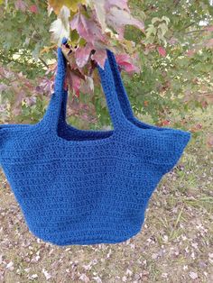 What's great about this tote that it is reversible so it's like getting two bags in one.   I made this tote bag with a navy yarn.    I Criss Crossed the Stitches working in the front loops only so you get the Criss-  Cross Design on side A; and you get a more solid design for Side B. Note that is hard to see the difference in the photos. of Side A & Side B . On the bottom of the bag on Side B there is a care tag sewn in which may show if using that side.  You can remove the care tag if you'd like. This bag would work great as a Reusable grocery bag , beach bag, book bag, or a tote to toss your things in and go.   Measurements: 13 " wide by 16 in tall not counting the straps. It is made from acrylic yarn.  Tote is machine washable & dryable.  I can make this custom for you in a different co Yarn Tote, Sewing Tags, Care Tag, Cross Design, Book Bag, Reusable Grocery Bags, Cross Designs, Grocery Bag, Beach Bag