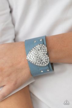 "Flauntable Flirt": Encrusted in blinding white rhinestones, an oversized silver heart frame is studded in place across the front of a blue leather band, creating a flirtatious centerpiece around the wrist. Features an adjustable snap closure. Sold as one individual bracelet. Emerald Style, Heart Frame, Ball Necklace, Paparazzi Accessories, Black Bracelets, Blue Gems, White Rhinestone, Paparazzi Jewelry, Affordable Jewelry