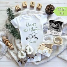 a baby's first christmas outfit and other items are laid out on a blanket