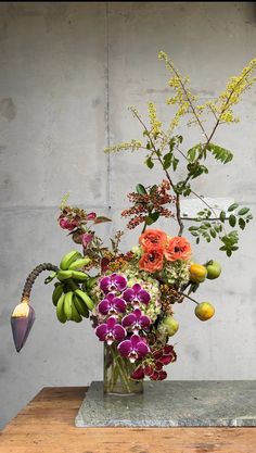 a vase filled with lots of different types of flowers