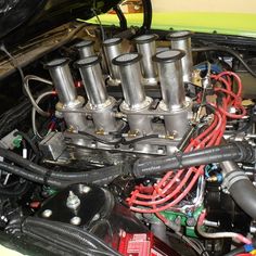 the engine compartment of a car with many different types of pipes and wires in it