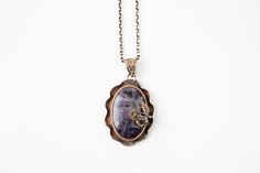 "This gorgeous pendant is made with a stunning polished Amethyst stone set in a 100% Bronze casing with the most delicate rose detail. The pendant comes with a matching chain measuring 17.5 inches. Pendant width: 1.25\" Pendant height: 2\"  All orders are shipped within 24 hours of payment. If you have ANY questions please feel free to ask =) Thank you for stopping by! Be sure to check out our other other items: cicijewelers.etsy.com" Elegant Oval Pendant Necklace With Soldered Details, Soldered Purple Pendant Jewelry, Purple Soldered Pendant Jewelry, Bohemian Amethyst Soldered Necklace, Engraved Amethyst Pendant Necklace, Bohemian Amethyst Necklace, Amethyst Flower Pendant Jewelry For Gift, Amethyst Flower Pendant Jewelry Gift, Asymmetrical Necklace