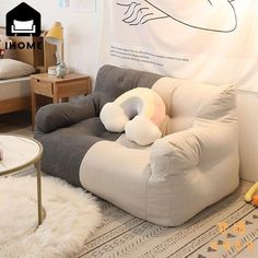 a living room with a couch, chair and rugs on the floor in front of a white wall