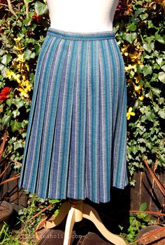 What a fab skirt from the 1970s. What makes this skirt so stunning is it’s length. In the 1970s everyday skirts were worn long but this one has been cut cleverly so that it sits at the knee. Perfect!  The teal, blue and grey fabric stands out immediately. It’d be perfect teamed with so many different colours and looks brilliant with denim. Browse and buy https://www.etsy.com/uk/listing/230811818/vintage-1970s-teal-blue-and-grey-box?ref=shop_home_active_1 Fabric Stands, Everyday Skirts, Box Pleat Skirt, Blue And Grey