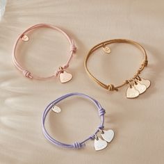 Wear your heart on your sleeve with our Personalized Heart Name Bracelet. Personalize the front and reverse of the mini heart charm with a hand engraved name, date or word, to pair alongside a vibrant braid color of your choice.&nbsp;18K Champagne Gold Plated, 925 Sterling Silver or 18K Rose Gold PlatedMini Flat Heart: 0.4x0.4Braid made of a durable, colorfast polyesterFully adjustable sliding knot fasteningHand-engraved in our Paris workshopSent with love in a complimentary gift boxAny slig Silver Heart Charm Bracelet, Adjustable Charm Bracelet With Heart Charm For Personalized Gift, Adjustable Heart Bracelet With Charms, Adjustable Heart Bracelet With Charms For Everyday, Adjustable Heart Charm Name Bracelet, Heart On Your Sleeve, Engraved Bracelet, Sliding Knot, Name Bracelet