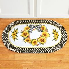 a sunflower wreath on a black and white checkered rug in front of a door