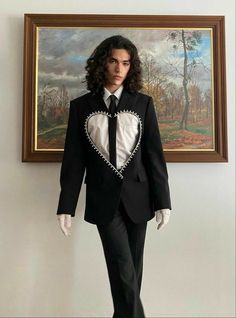 a mannequin dressed in a suit and tie next to a painting